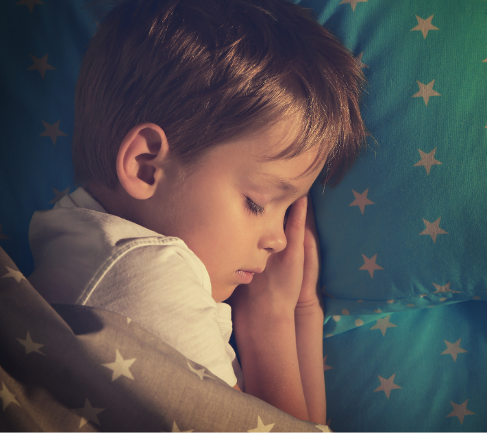 Young boy sleeping on star sheets