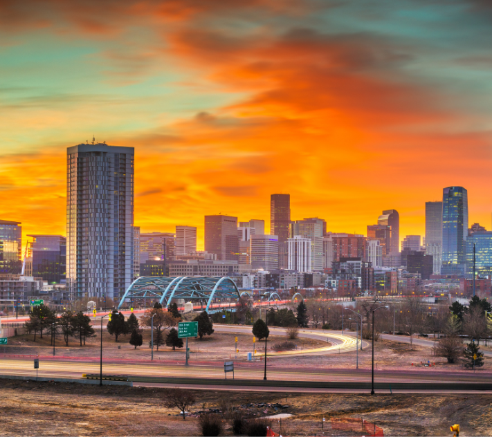 Denver skyline with tall buildings at dusk